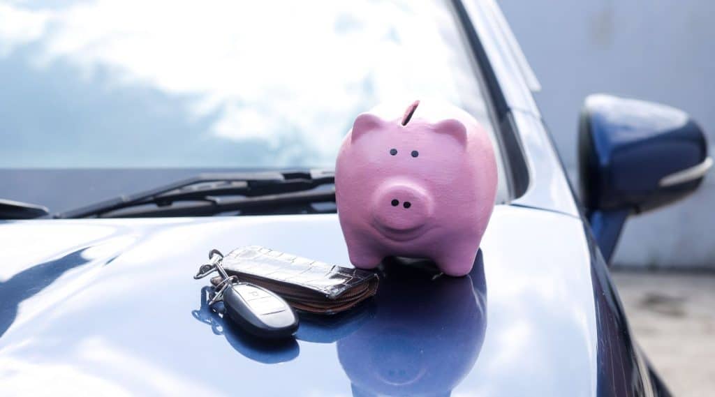 Piggy bank sitting on top of vehicle bonnet