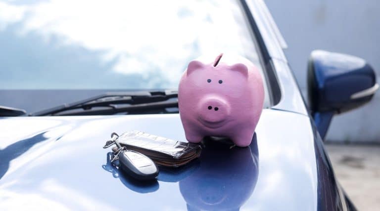Piggy bank sitting on top of vehicle bonnet