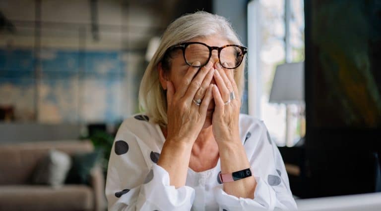 A stressed woman covering her face