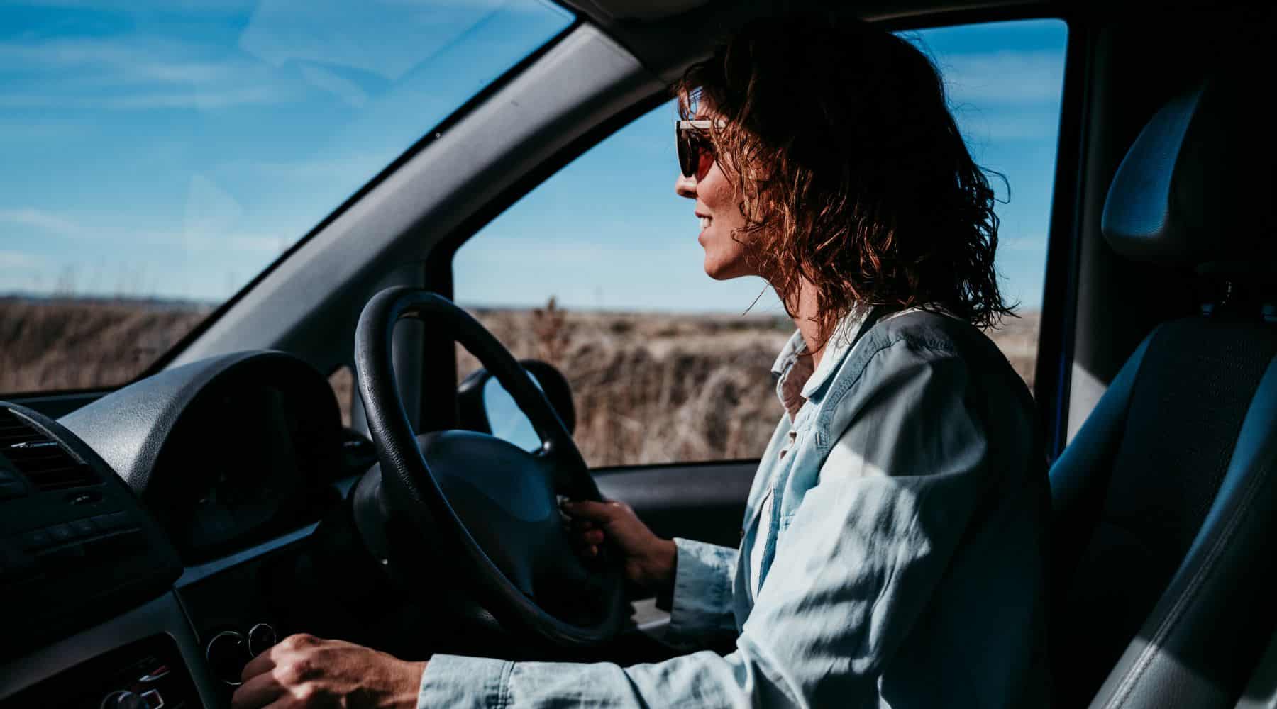 Woman driving her car in the countryside