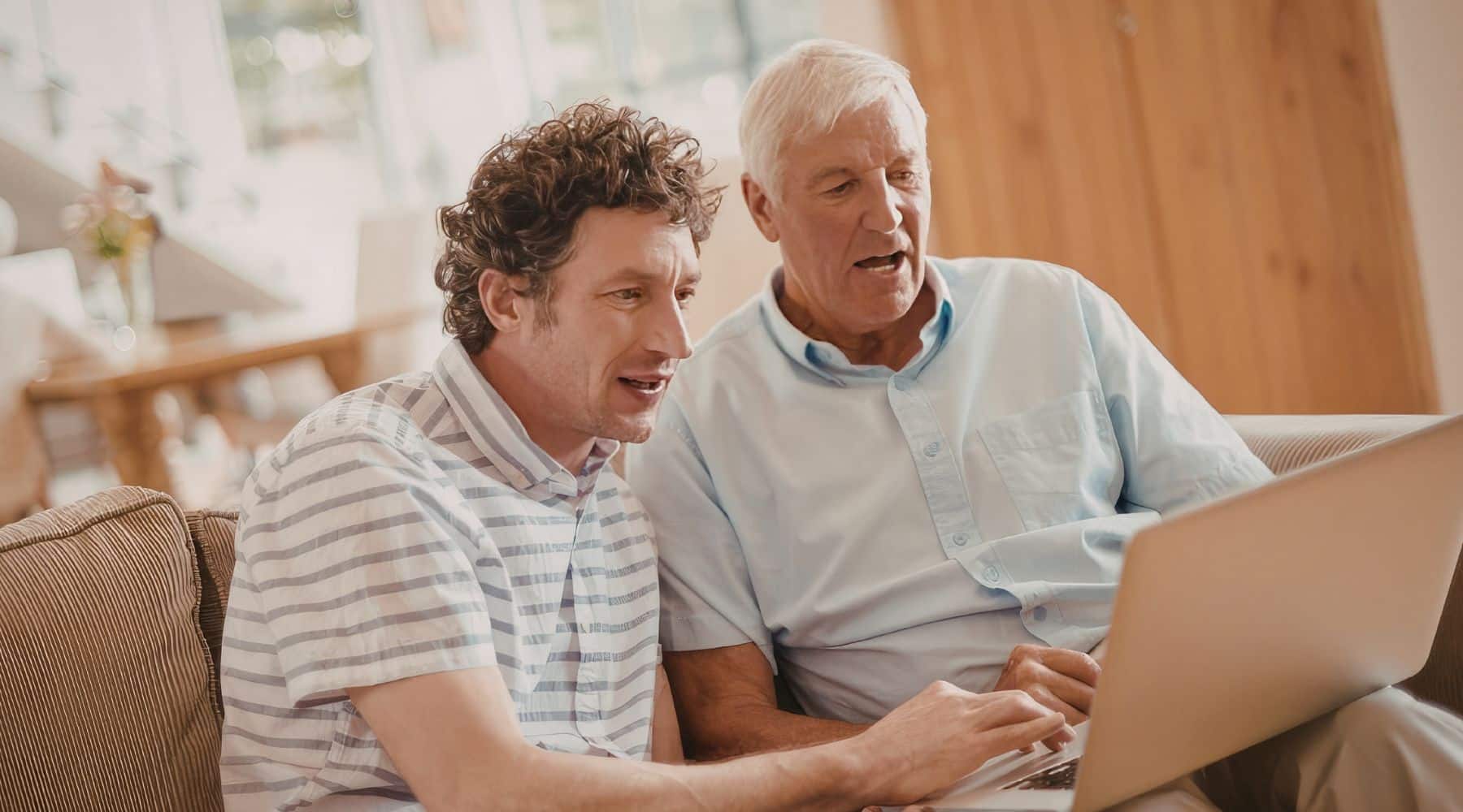 Senior man looking at laptop with his son