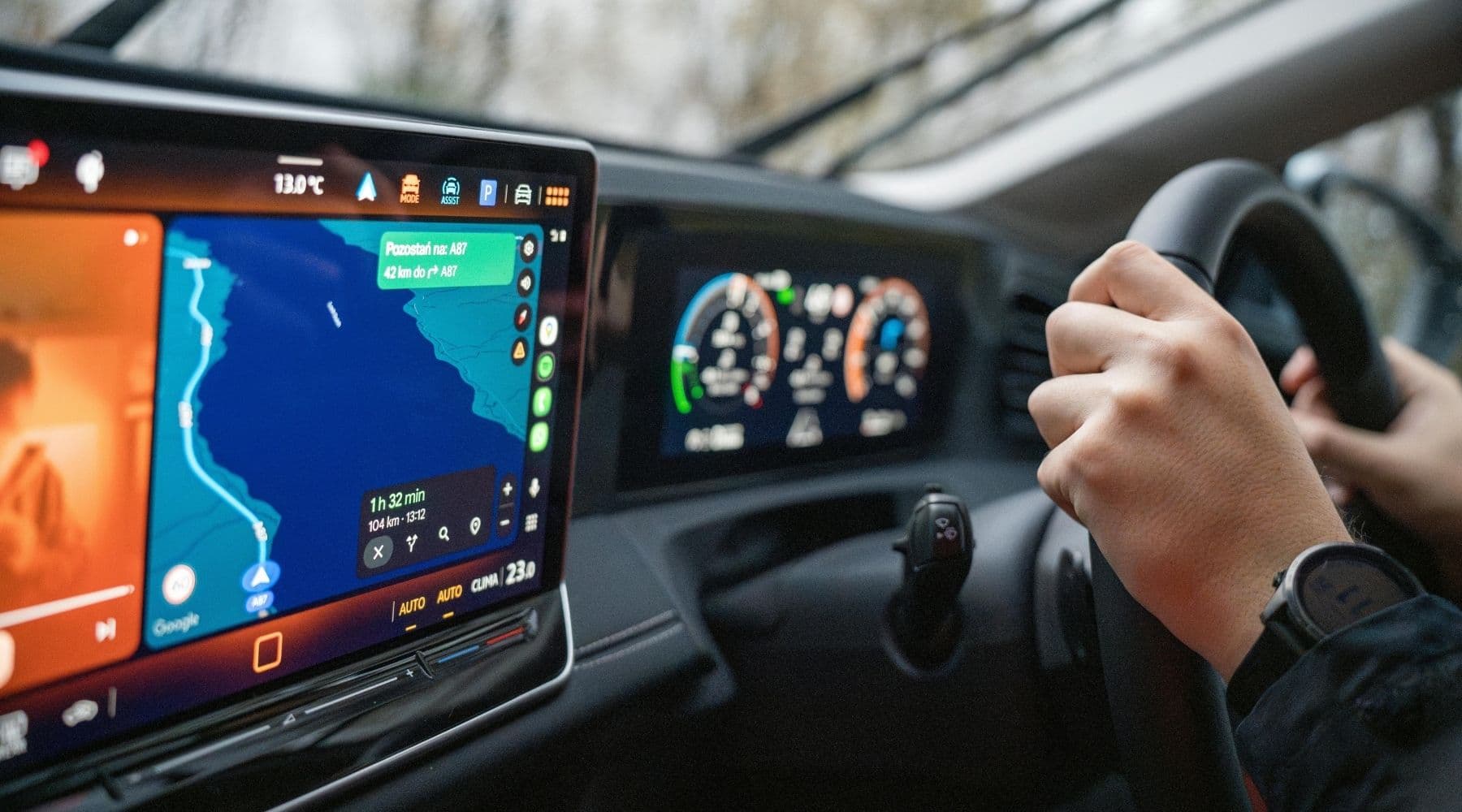 Person driving a connecged car with the screen on showing directions